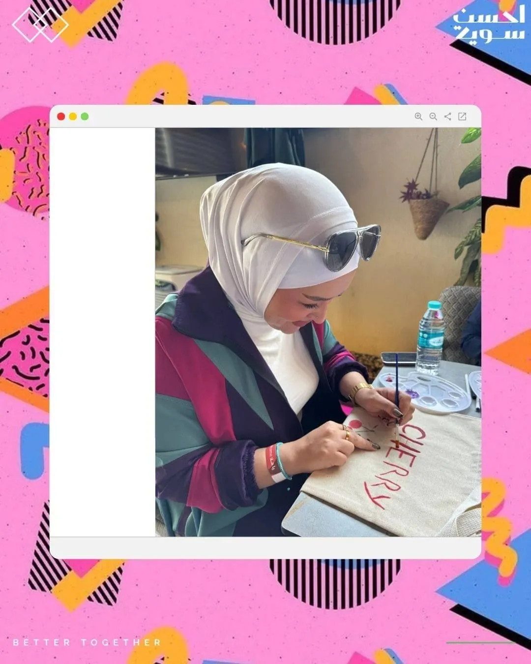 A participant paints her canvas tote