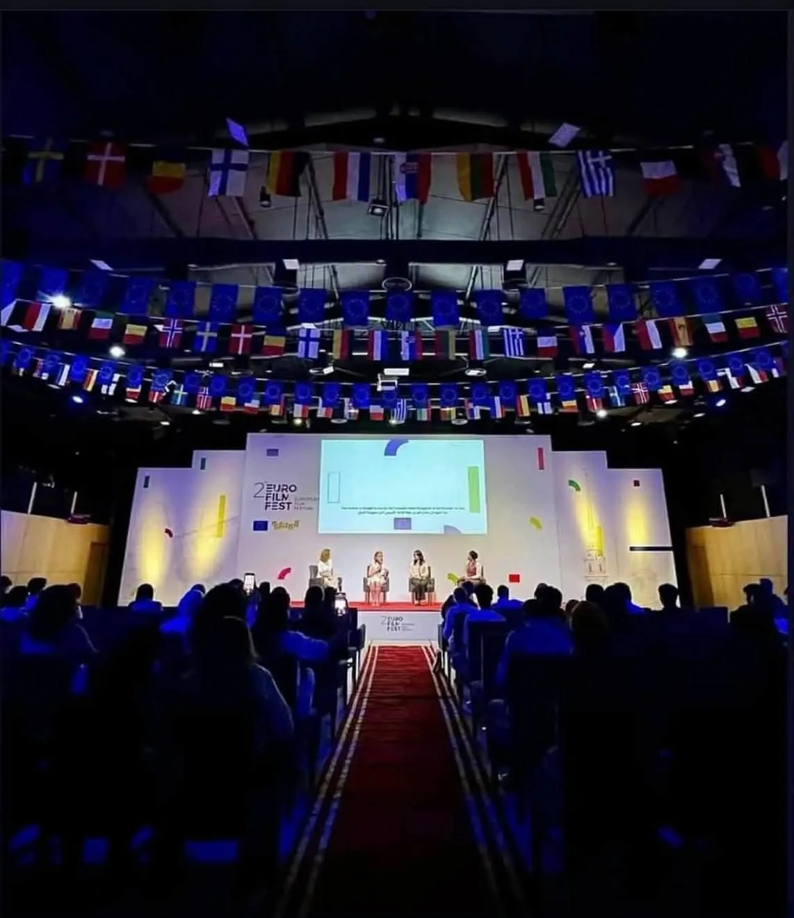 The packed festival hall under the flags of European countries