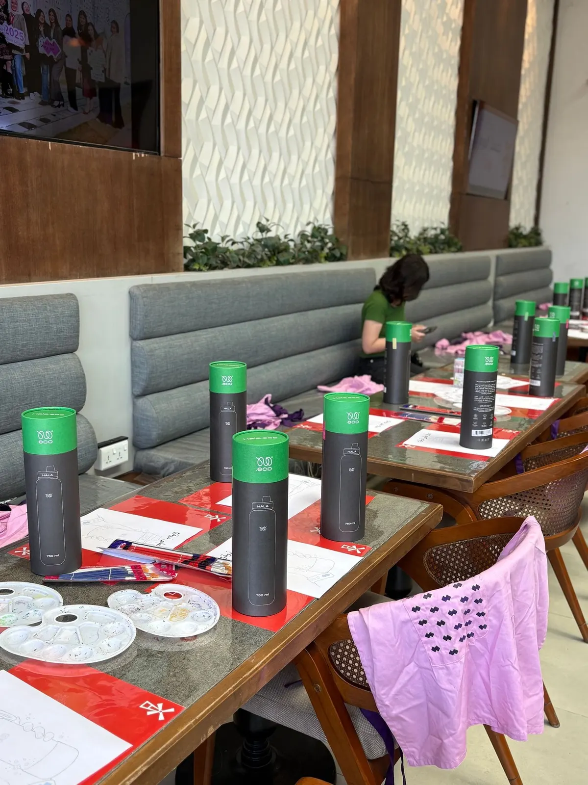 Workshop tables set with water bottles and paints